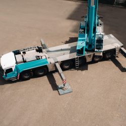 view from the height of the Car heavy crane that stands open in the Parking lot and ready to work. the highest truck crane is deployed on the site. the height of the boom is 80 meters.